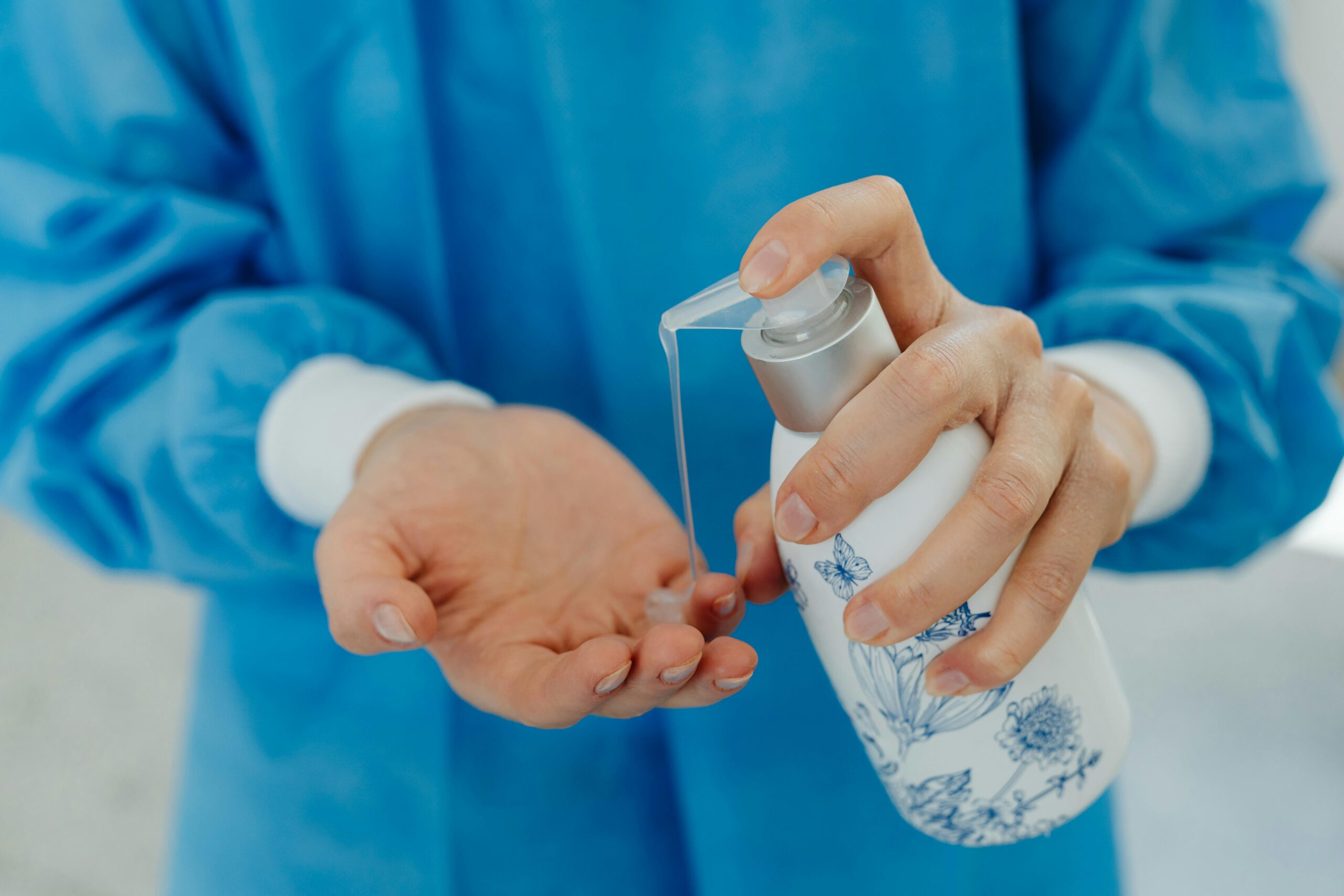 Detailed image of hands applying hand sanitizer, emphasizing hygiene and cleanliness.